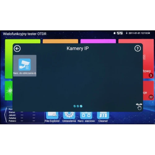 Ekran urządzenia wielofunkcyjnego testera OTDR z wyświetlonym menu aplikacji, w tym ikoną "Narz. do obliczania d...". W tle widoczne są kolorowe kafelki z różnymi funkcjami oraz pasek statusu z datą i godziną.