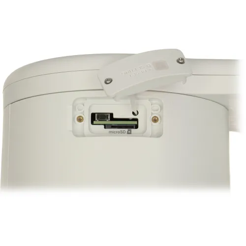 Zdjęcie przedstawia białe urządzenie z otwartą klapką, ukazującą gniazdo na kartę microSD oraz przycisk reset. Klapka jest lekko uniesiona, a na niej widoczny jest napis "RESET SETTING".