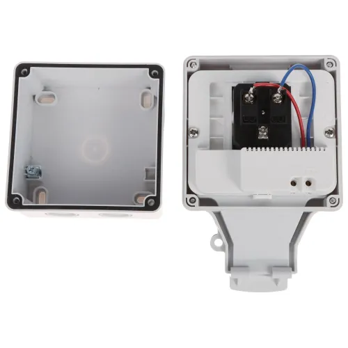 Zdjęcie przedstawia otwartą plastikową obudowę elektryczną z widocznymi przewodami i zaciskami wewnątrz. Obudowa składa się z dwóch części: pokrywy i podstawy, które są pokazane obok siebie.