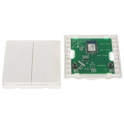 Na zdjęciu widoczna jest otwarta obudowa urządzenia elektronicznego z płytką drukowaną, na której znajdują się różne komponenty, w tym moduł komunikacyjny. Obok leży zamknięta część obudowy z dwoma przyciskami.