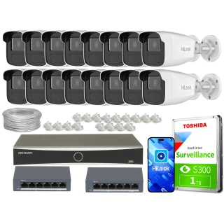 Zestaw do monitoringu składa się z szesnastu kamer HiLook, dwóch switchów, rejestratora Hikvision, dysku twardego Toshiba oraz akcesoriów montażowych. Na zdjęciu widoczne są również przewody i złącza sieciowe.