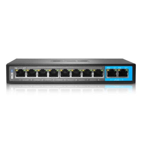 Na zdjęciu znajduje się czarny switch sieciowy BCS z ośmioma portami Ethernet, z czego jeden port jest wyróżniony niebieską ramką. Na górnej części urządzenia widoczne jest logo BCS.