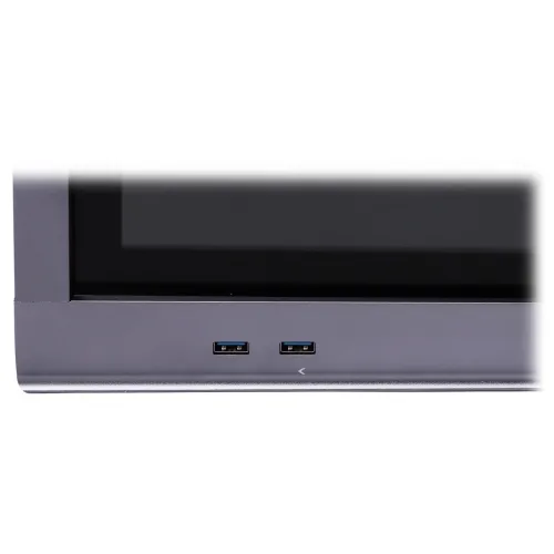 Zdjęcie przedstawia dwa porty USB umieszczone na dolnej krawędzi urządzenia elektronicznego. Obudowa urządzenia jest w kolorze szarym, a porty są oznaczone niebieskimi elementami.